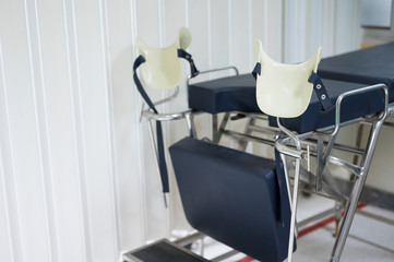 Empty gynecological chair in the clinic.Gynecological bed on the obstetrics and gynecology department in the hospital.Medical equipment concept.