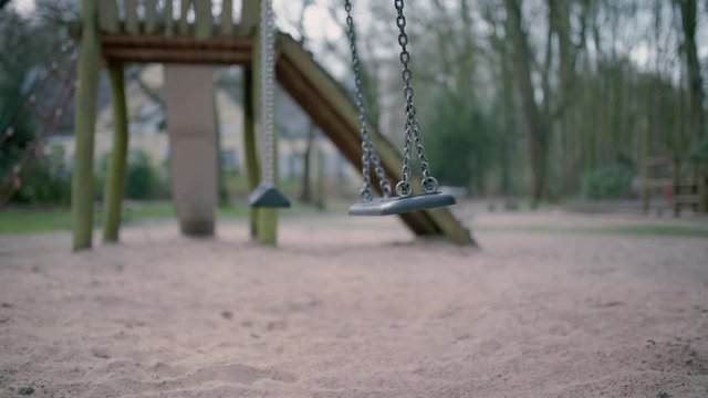 Empty swing during state of emergency by the reason of covid-19 virus threat slow motion