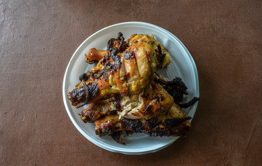 Fried chicken legs roasted over charcoal in the grill with a delicious crispy crust. Closeup view from the top. 