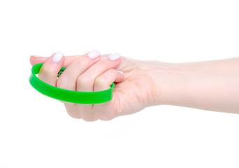 Green rubber bracelet on hand on white background isolation