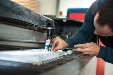 Electrical engineer repairs CNC computer numerical control laser cutting head