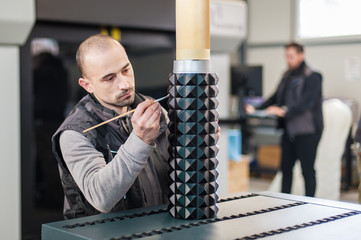 Technician processing large model printed on modern 3d printer machine