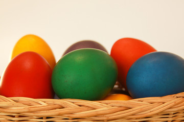 Easter eggs colors in basket white background
