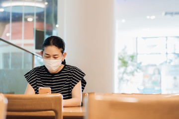 Social distancing. Asian woman wears cotton face mask