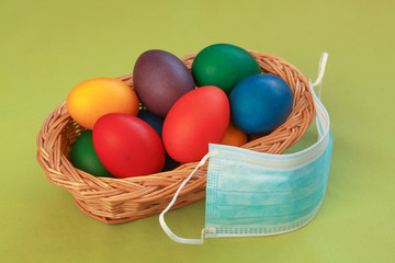 Colored eggs in basket medical mask Easter 2020