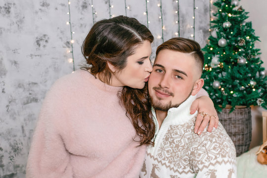 mom kissing her son at christmas photo