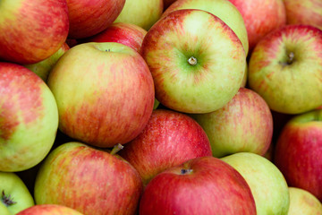 Fresh apples on a vegetable market or in a supermarket for sale in close-up