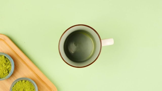 process of drinking matcha tea from cup, stop motion animation, top view
