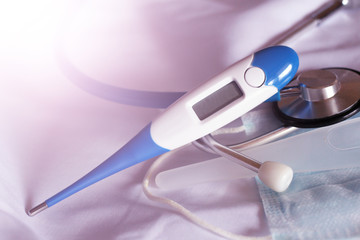 Blue stethoscope and electronic thermometer
