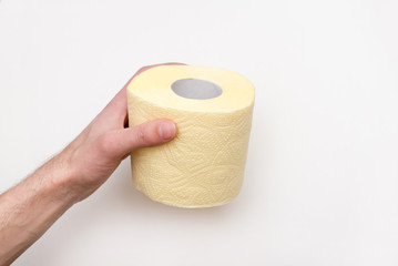 hand holding yellow toilet paper over white background