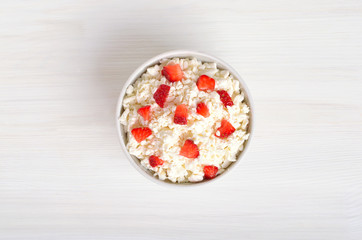 Curd cheese and strawberry in bowl