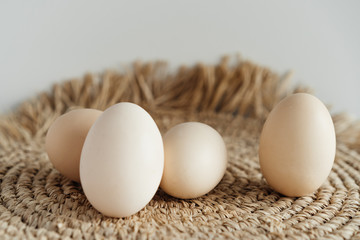 chicken eggs on a natural straw napkin