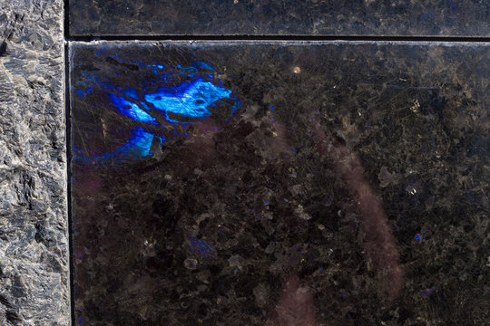 Texture of natural black labradorite stone. Natural blue mineral stone labradorite crystal in the rock. High resolution photo.  