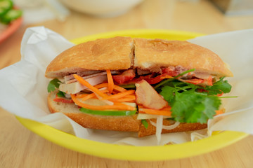 banh minh with roast pork - cut in half