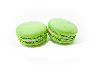 two bright green macaroons on a white isolated background
