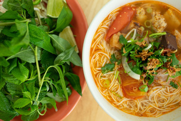Thai tomato noodle soup - with blood cubes, fried onion, fresh thai basil