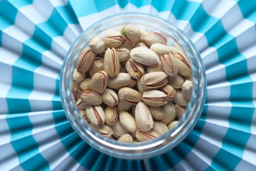 top view of pistachios in a jar on color background 