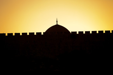 The dome of the rock behind the Old City wall of Jerusalem.