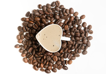 Cup of espresso coffee on the coffee beans background.