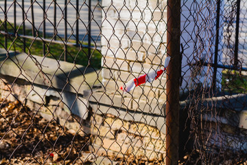 barrier red white stripped ribbon, fence and wire