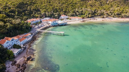 Aerial view of Portinho da Arrábida beach, in Setúbal, Portugal. Transparent water beach
