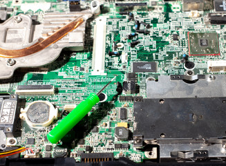 repairing a broken laptop, unscrewing screws with small screwdrivers