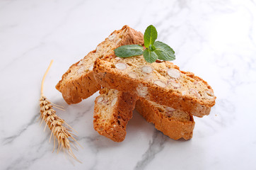 Biscotti with nuts on a marble background decorated with leaves mint. selective focus