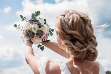 wedding bouquet in hands of the bride.