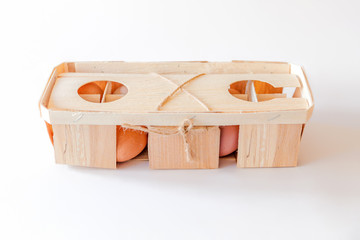 Ten natural fresh brown eggs in eco-friendly wooden packaging