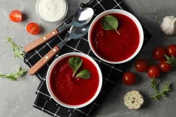 Tomato cream soup on grey background, top view