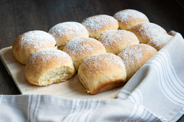 Fluffy homemade austrian powdered buchteln decorated on wooden board