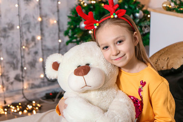 Fototapeta na wymiar little girl hug bear at christmas photo