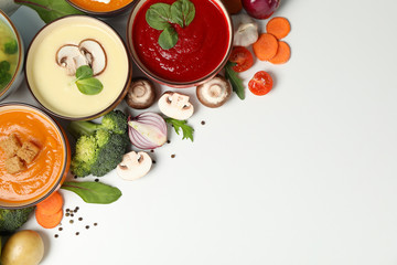 Vegetable soups and ingredients on white background, space for text