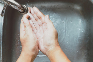Fototapeta premium washing hands at the sink in kitchen