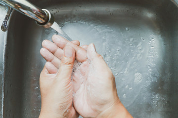 Fototapeta premium washing hands at the sink in kitchen