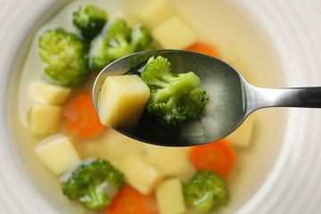 Spoon with potato and broccoli. Vegetable soup