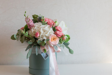A large flower arrangement in a hat box was created by a florist for a wedding gift. Hydrangea,...