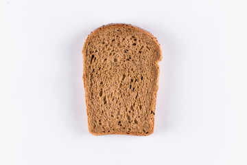 Slice of brown bread on white background
