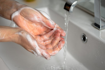 Fototapeta premium woman washing her hands in the bathroom