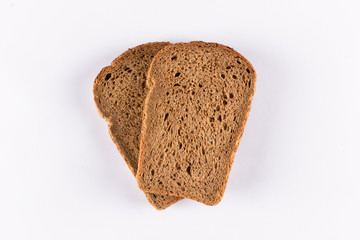 Two slices of brown bread on white background