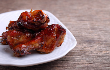 Baked chicken wings in soy sauce and honey, on a dark background