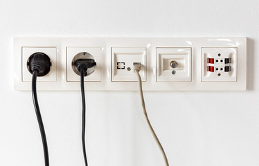 Sockets for electrical appliances on a white wall