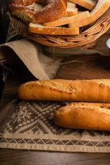 French baguette with slices of bread and bagels in basket