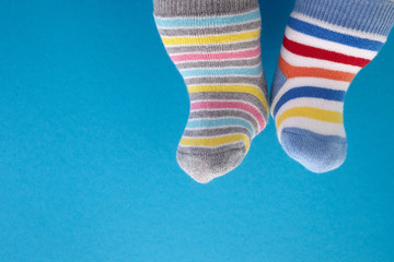 World Down syndrome day background. Down syndrome awareness concept. Socks and ribbon on blue background