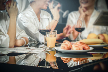 Young happy women spending time together, eating, drinking, talking. Friends at home.