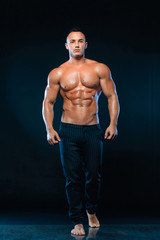Fototapeta na wymiar Portrait of handsome stylish man bodybuilder with naked torso.
