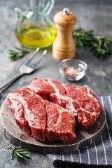 Raw beef steak on dark gray background