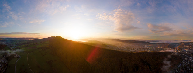 Fototapeta na wymiar aerial panorama of the sun rising on a misty morning