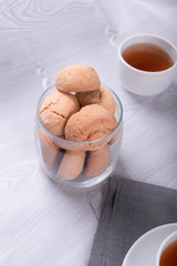 Cup of tea with jar of biscuits