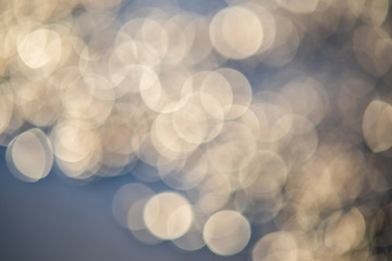 Abstract background of soft creamy bokeh circles.